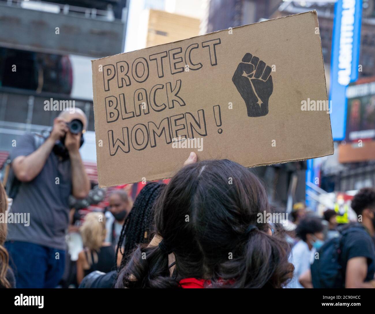 Black Womans/Womxns March Black Lives Matter Protest - Times Square New York CIty - Protect Black Women Protest Sign with photographer Stock Photo
