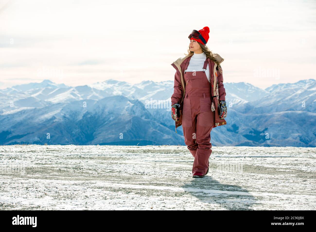 Beautiful asian woman enjoying and relaxing view with snow flake on snow mountain during winter in New Zealand. Stock Photo
