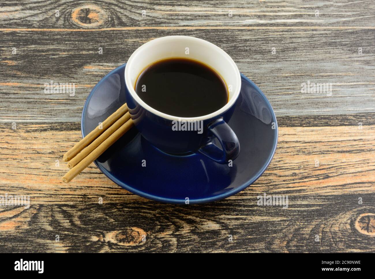 Demi-tasse cup of coffee with kona coffee flavored biscuit snacks on table Stock Photo