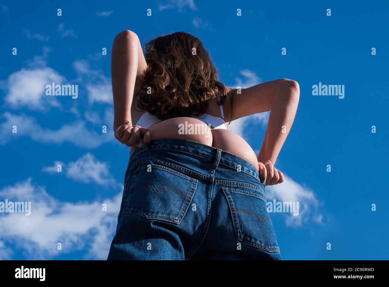 Big buttocks. Sexy girl takes off her pantie and shows a beautiful ass.  Girls undressed. Sexy buttocks women in jeans Stock Photo - Alamy