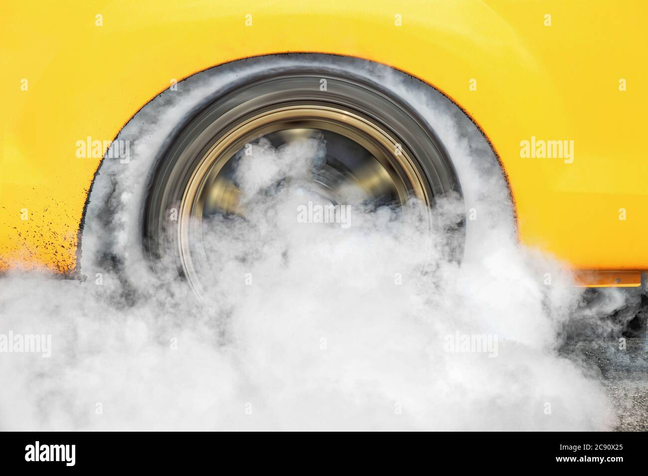 Drag racing car burns rubber off its tires in preparation for the race ...