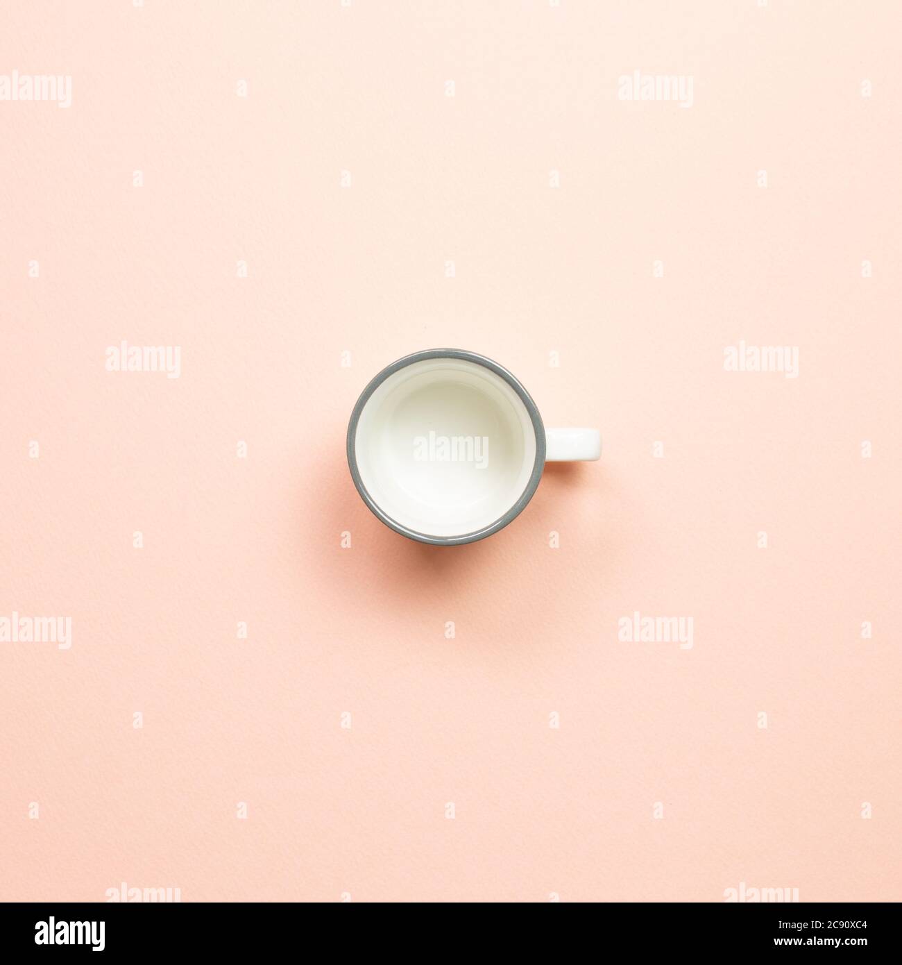 White empty mug cup on pink background. top view Stock Photo