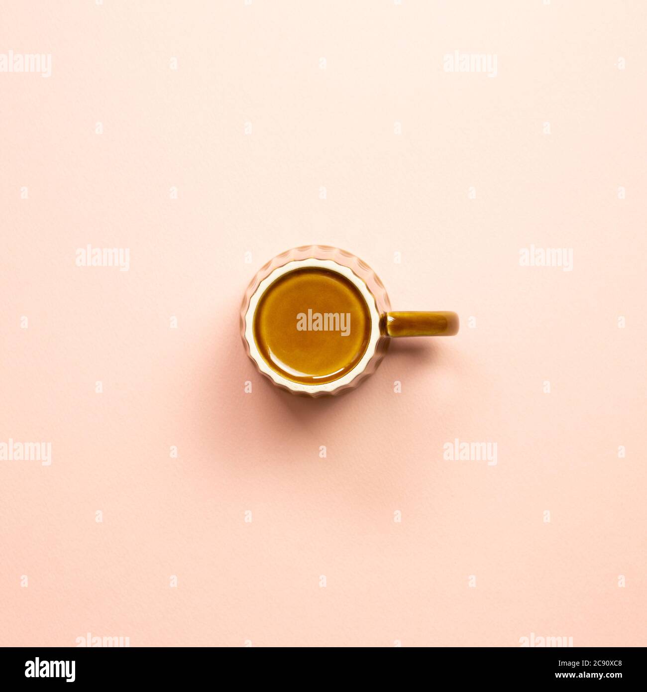 Brown empty mug cup on pink background. top view Stock Photo
