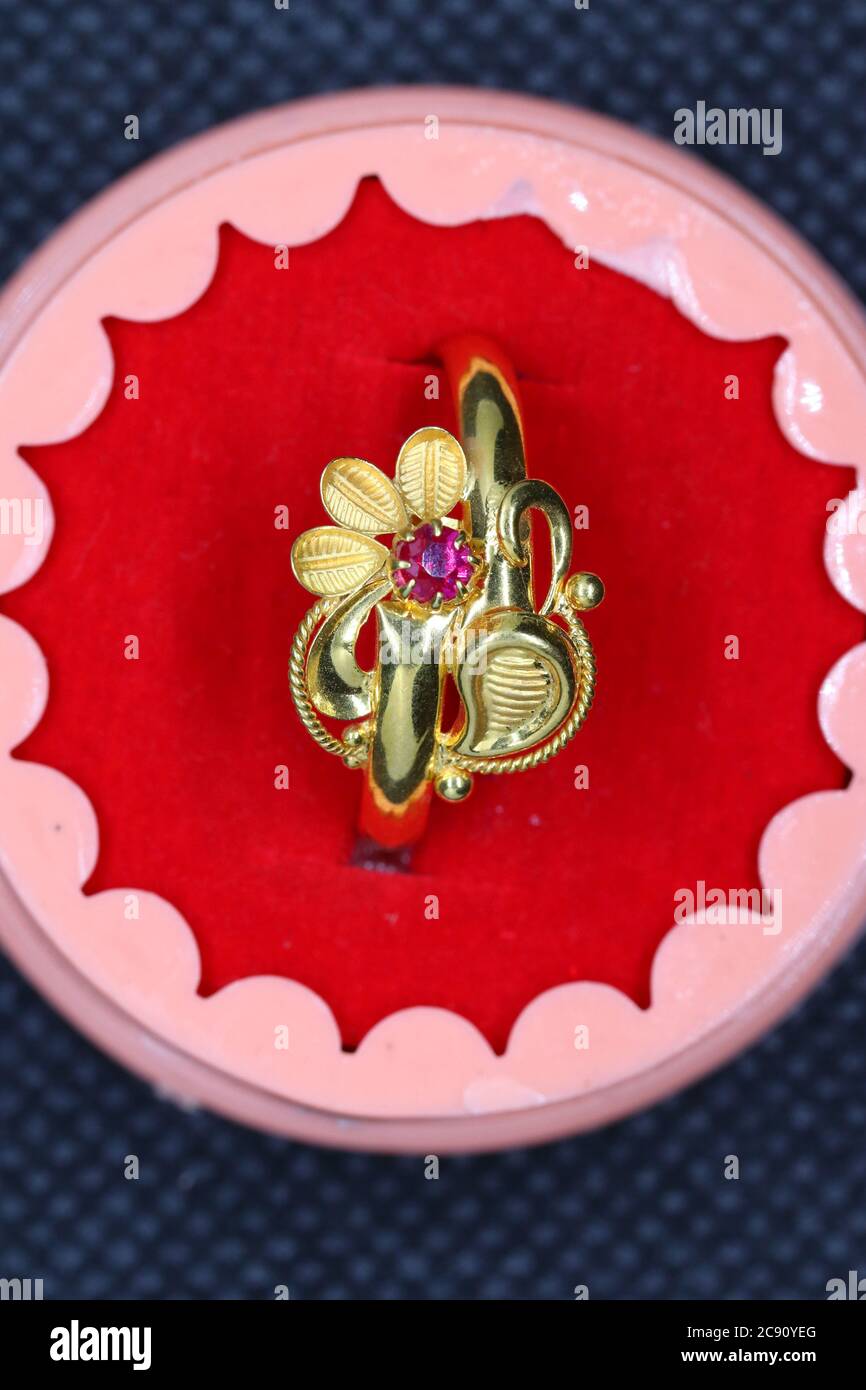 A red diamond gold ring featuring a flower design and beautifully drawn