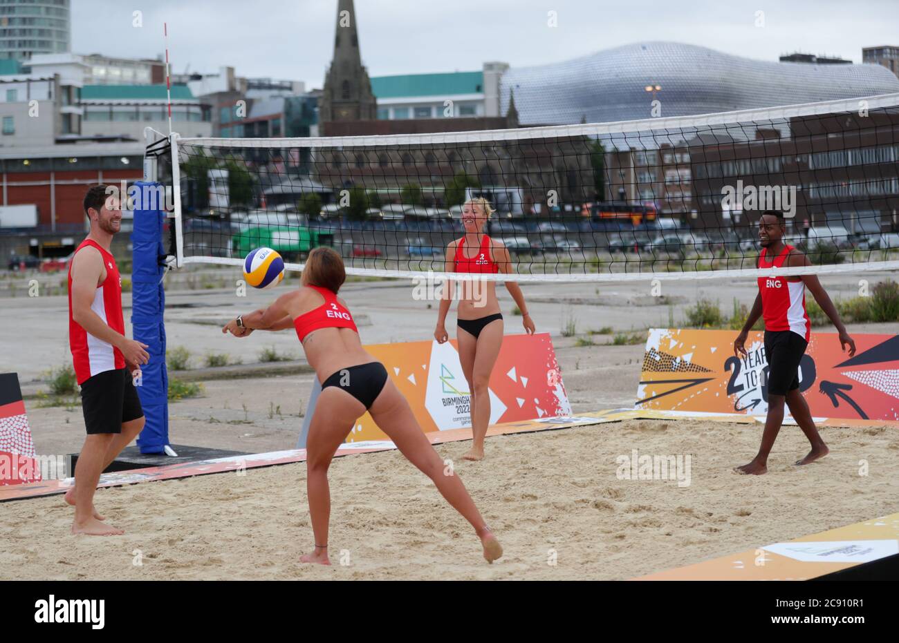 Team England players play beach volleyball during a demonstration at Smithfield, Birmingham City Centre. The Birmingham 2022 basketball and beach volleyball competitions will take place in the city centre location of Smithfield, Smithfield is the site of the former Birmingham Wholesale Market, which was cleared in 2018 and is the focus of a major regeneration plan. Stock Photo