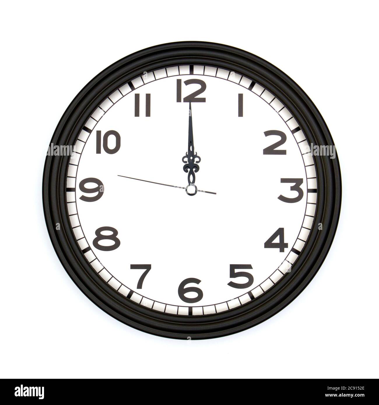 Black round analog wall clock isolated on white background, its twelve oclock. Stock Photo