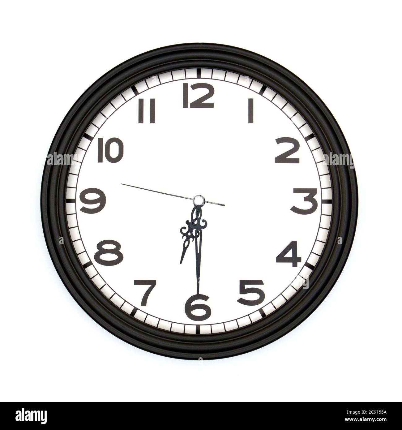 Black round analog wall clock isolated on white background, its half