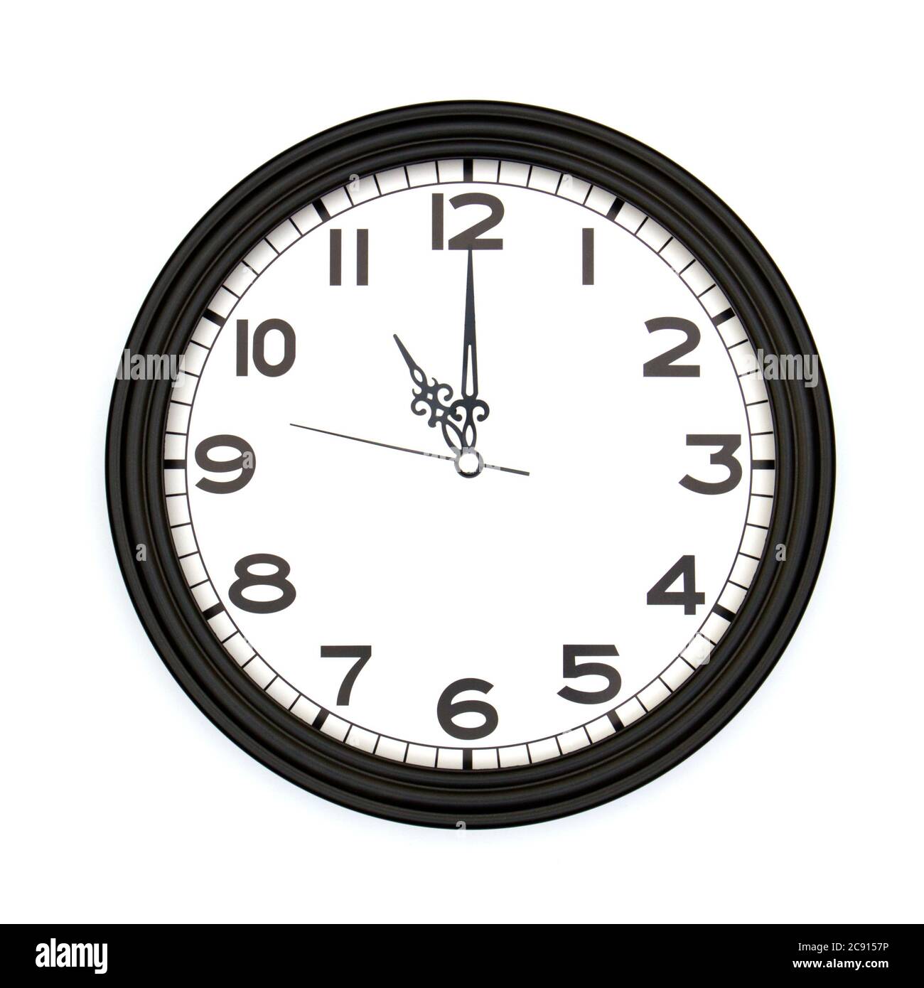 Black round analog wall clock isolated on white background, its eleven ...