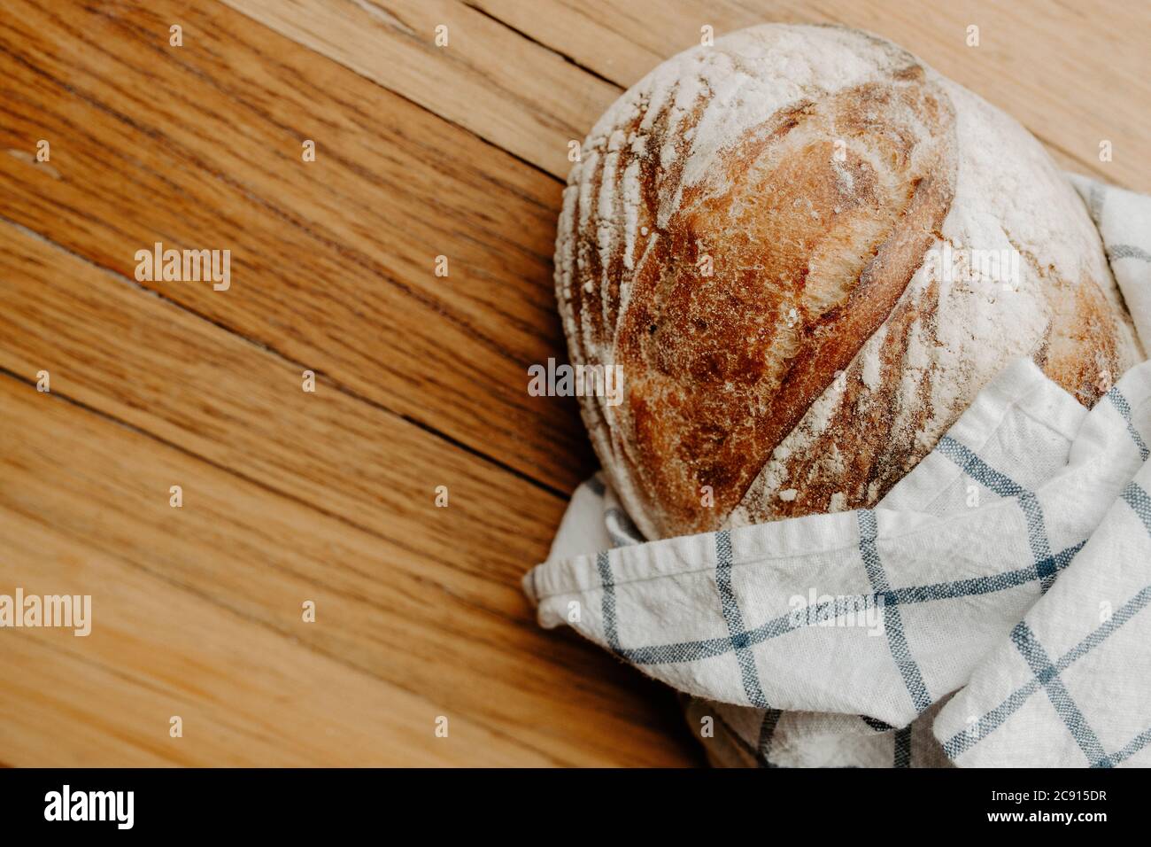 Fresh Homemade Artisan Bread On A Cutting Board With Tea Towel And