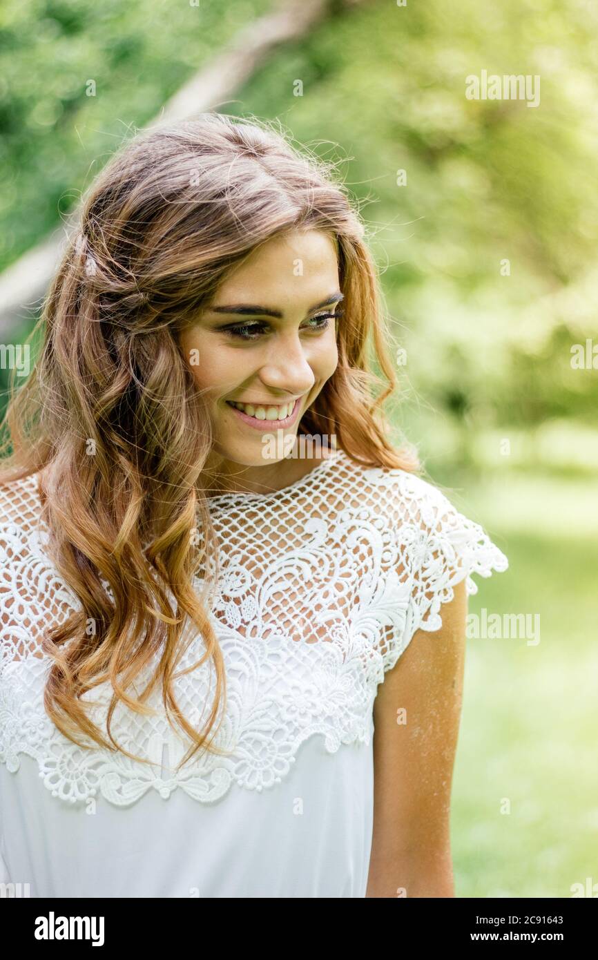 Beautiful young girl smiling on the green forest Stock Photo - Alamy