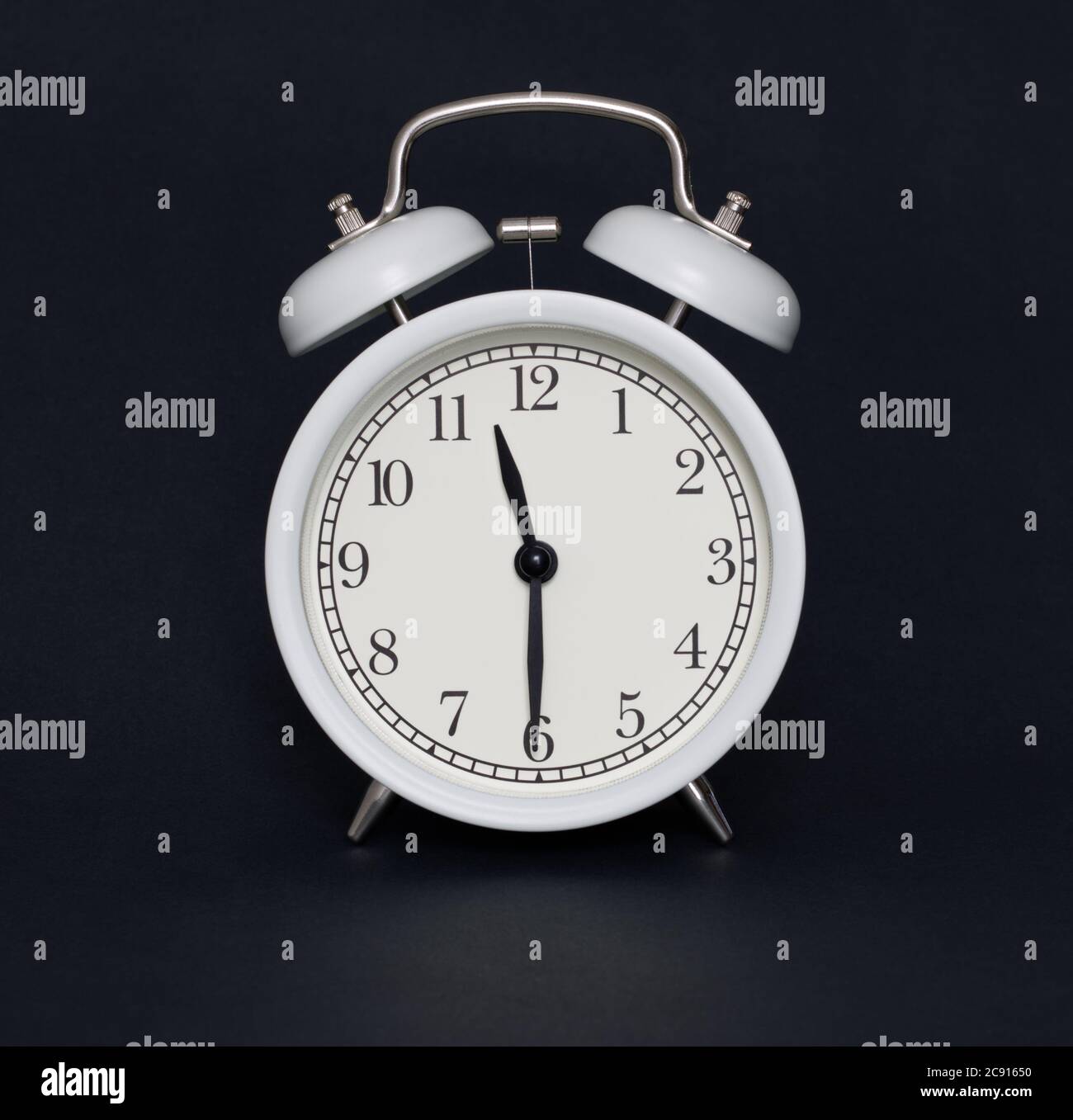 Old-style alarm clock, black and white, it's half past eleven. Stock Photo