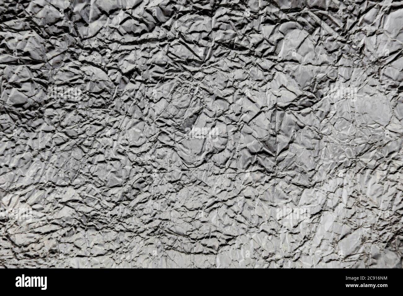 Crumpled wrinkled silver foil texture Stock Photo
