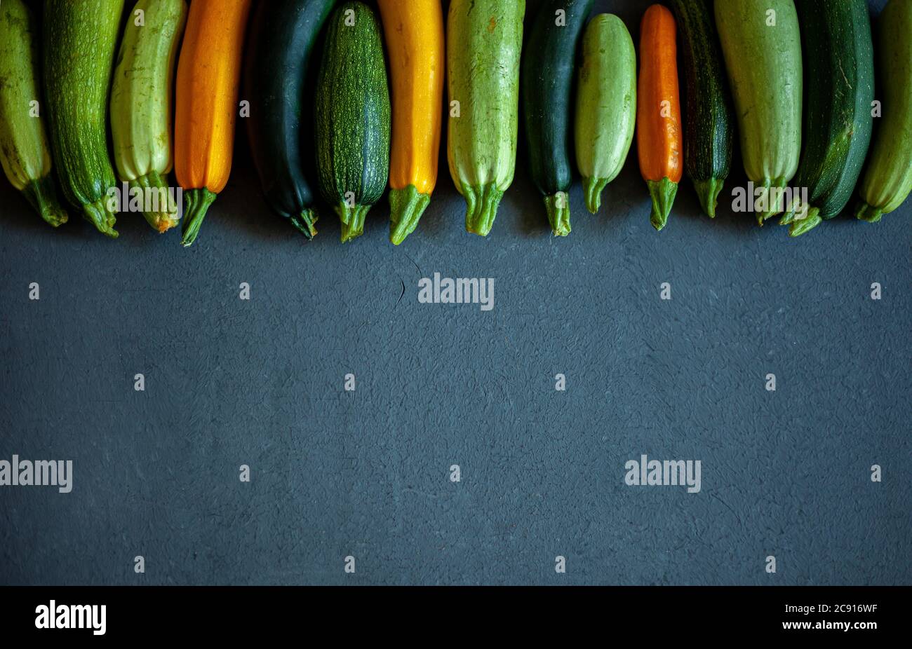 Fresh zucchini of different colors green, yellow, orange, white