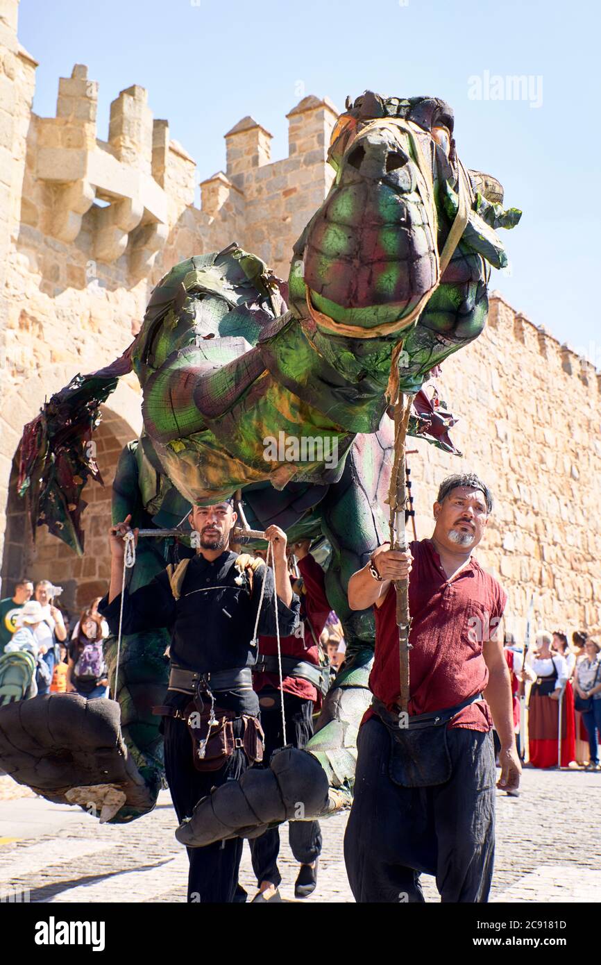 Avila, Spain - September 6, 2019 - Green dragon at a party next to the medieval wall of Avila Stock Photo