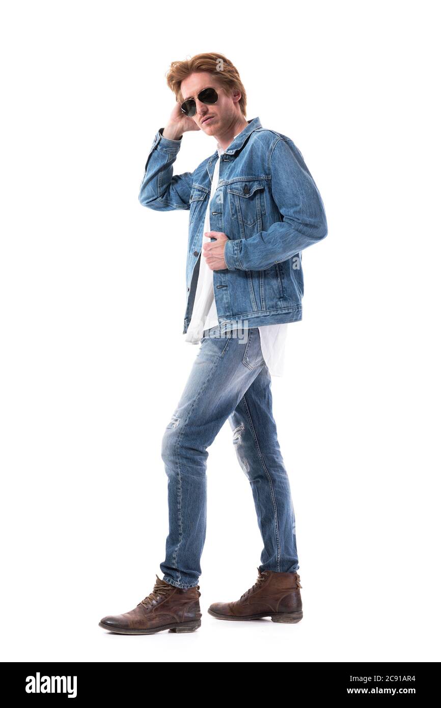 Side view of handsome young man wearing denim jacket and jeans with