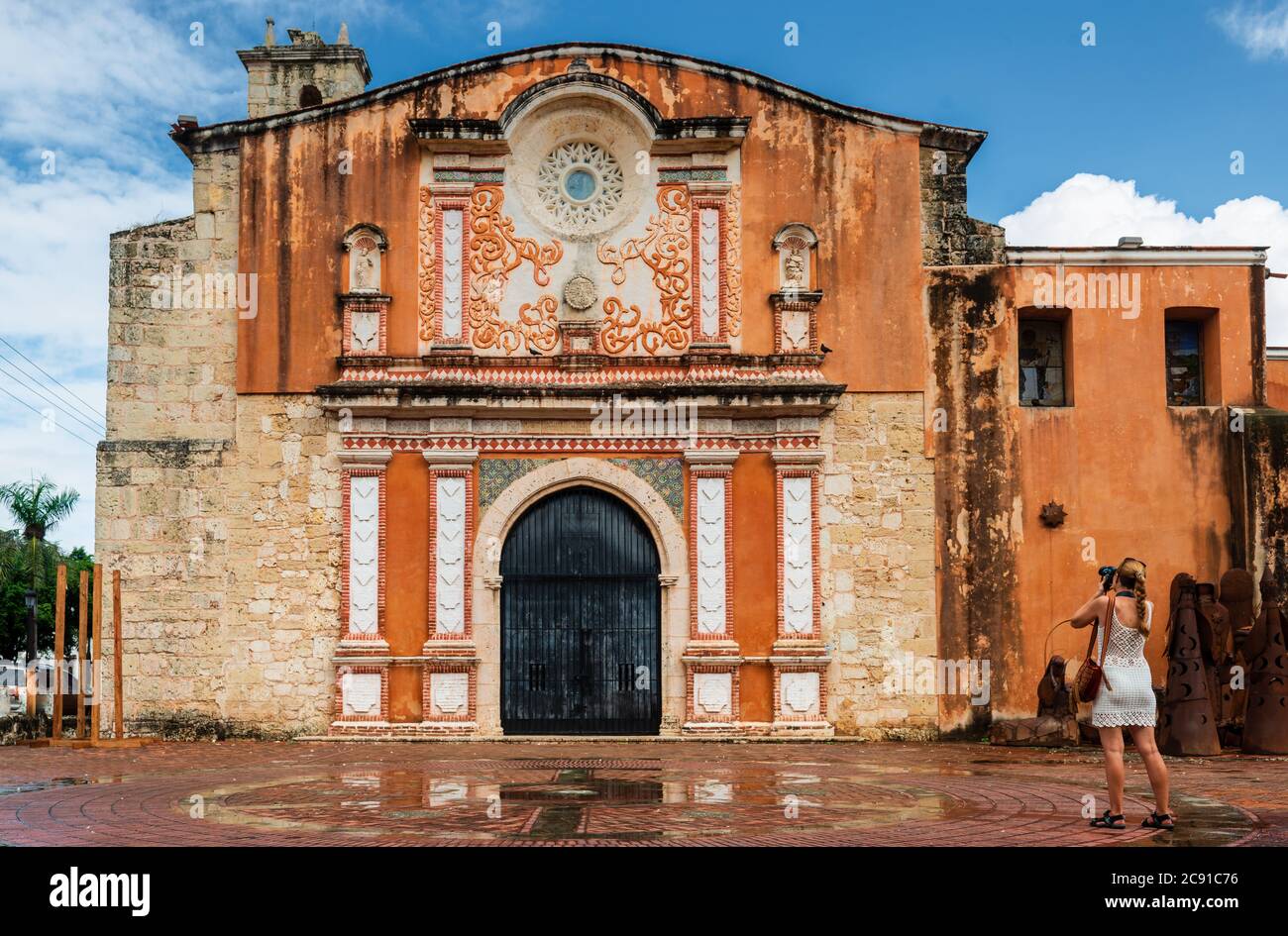The tourist is photographing the facade of the Convento de la Orden de los Predicadores in Santo Domingo Stock Photo