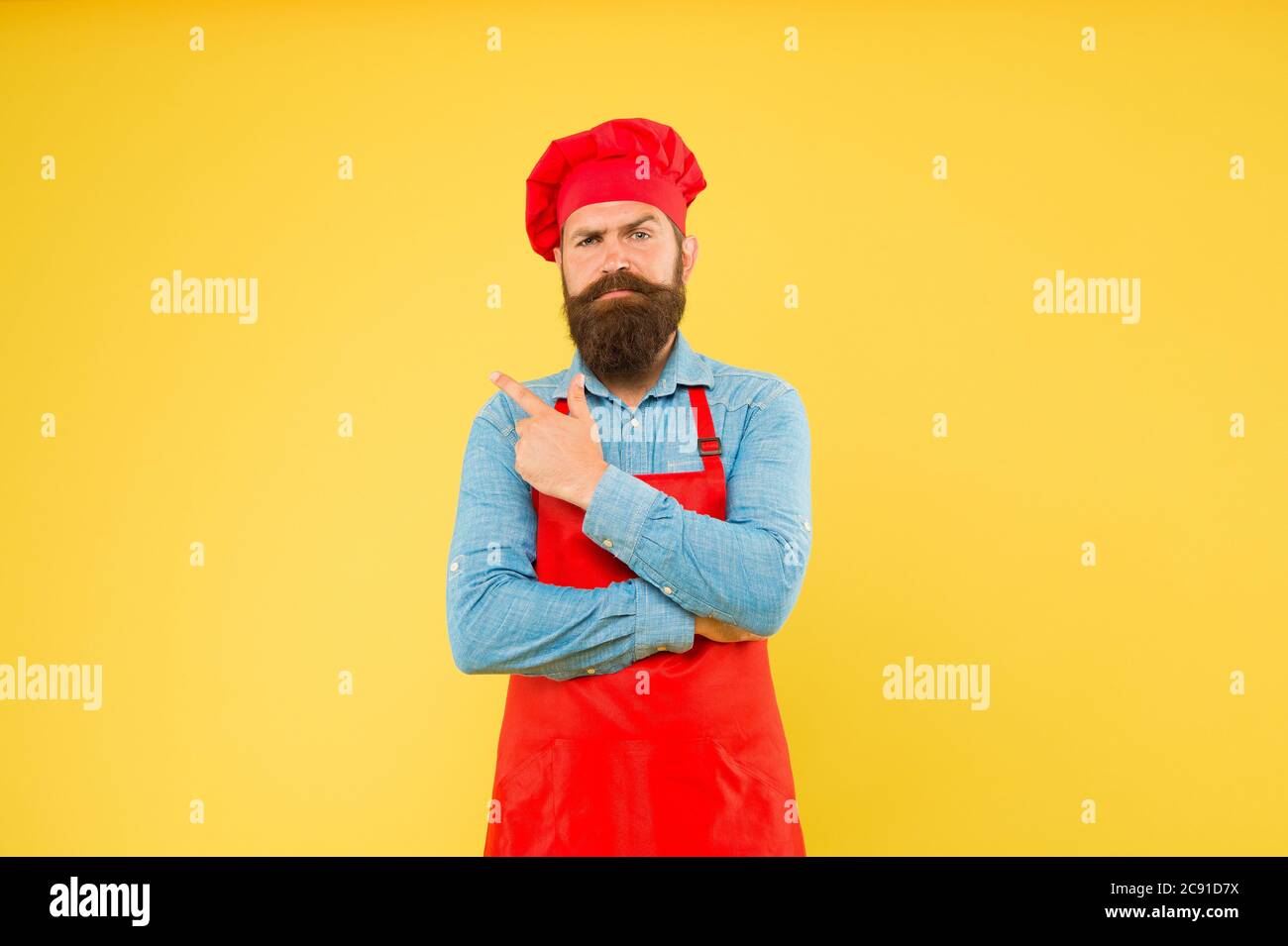 Food with thought. mature male chef at yellow wall. serious man cooking