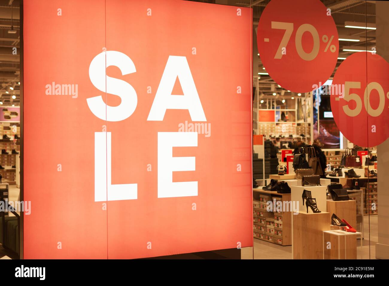 Red sale banner on store window. Promotions and discounts in shop Stock