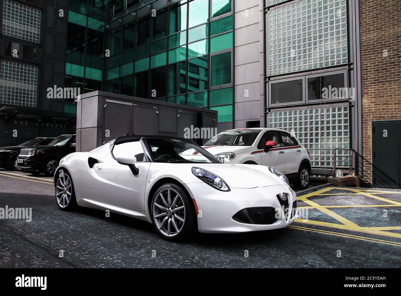 White Alfa Romeo 4C Spider modern sports car parked on a street of Mayfair area of Central London. Stock Photo