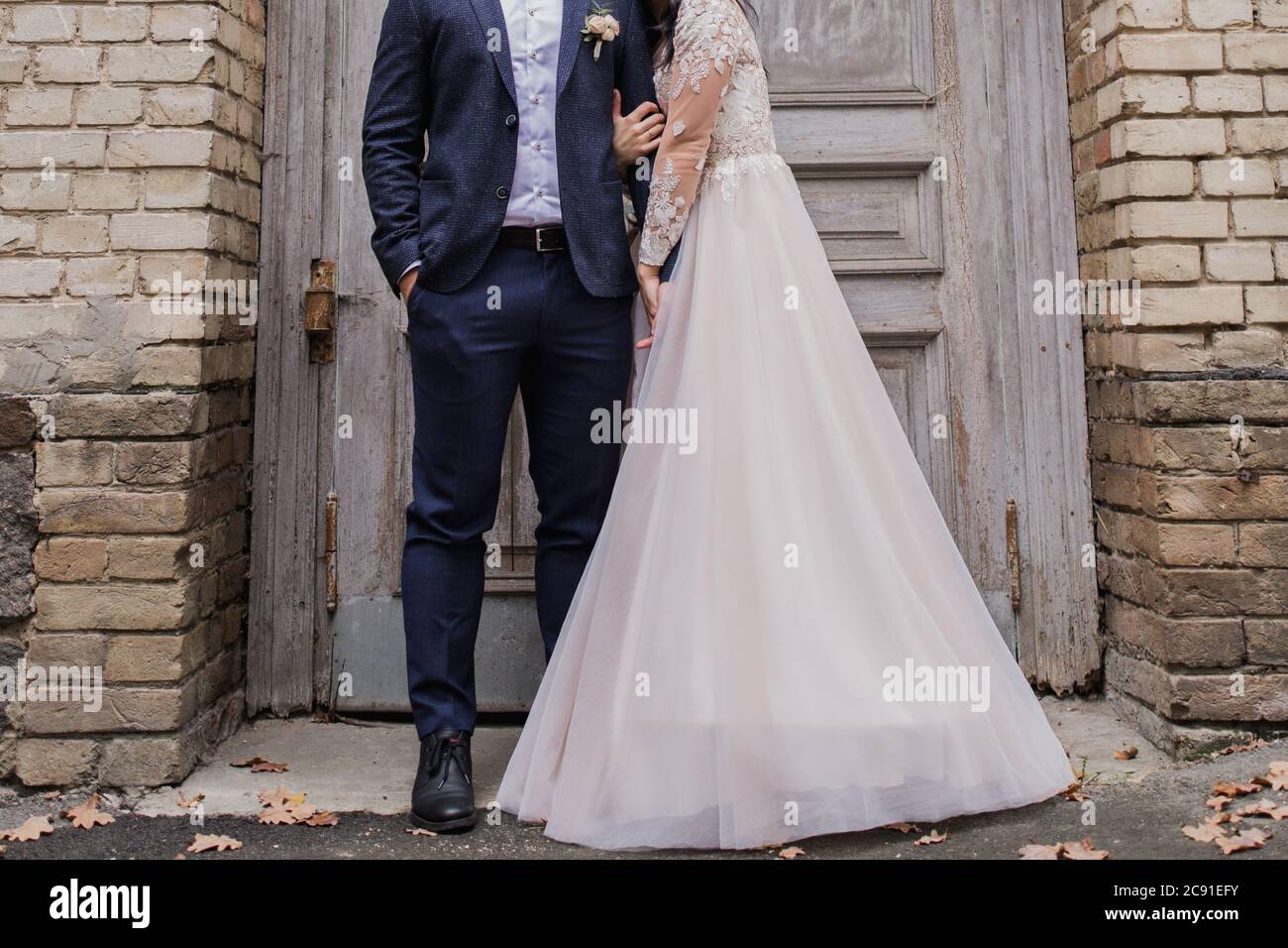 a groom with bride near the old door Stock Photo - Alamy