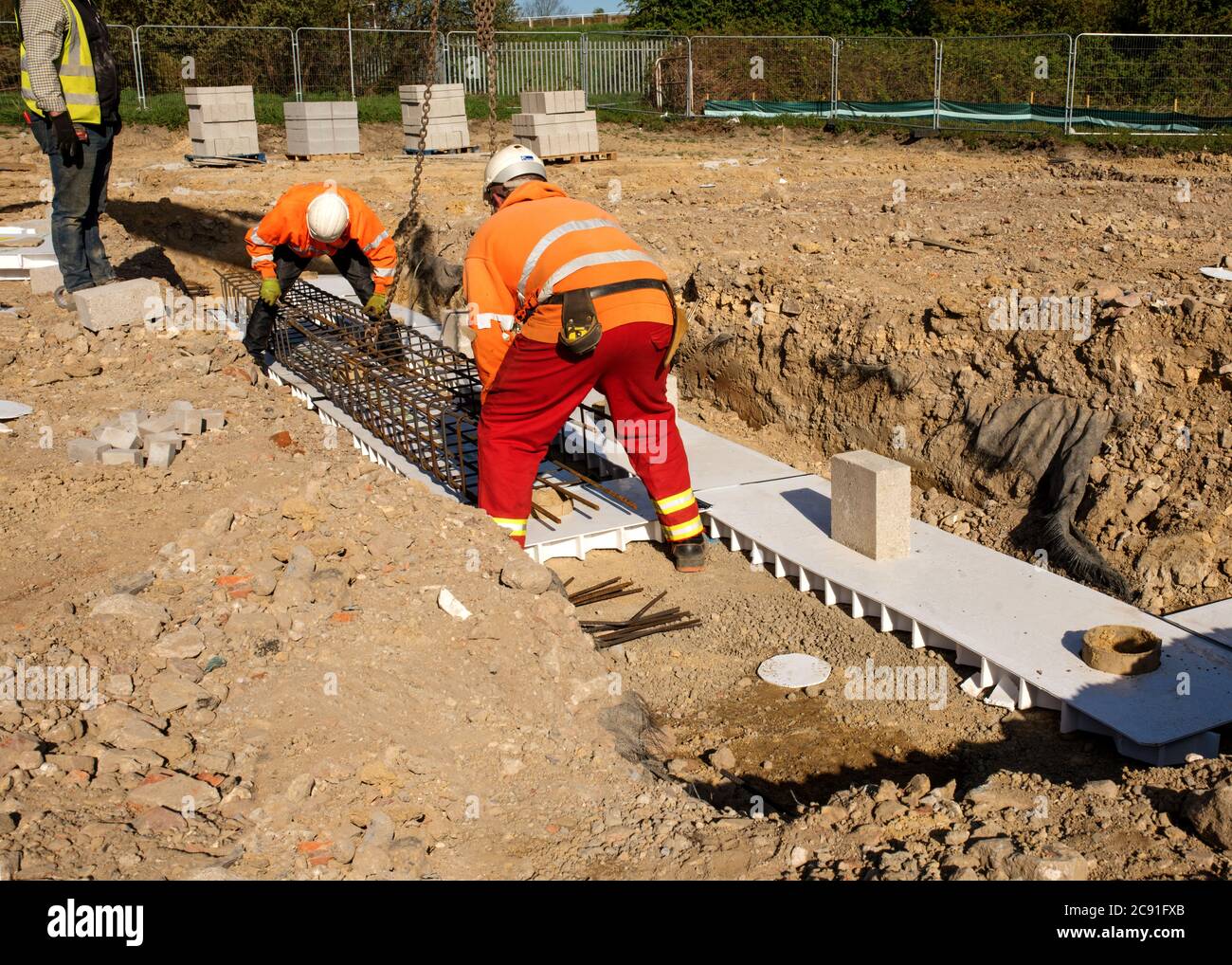 Groundworker is installing internal drainage for a house Stock Photo Alamy