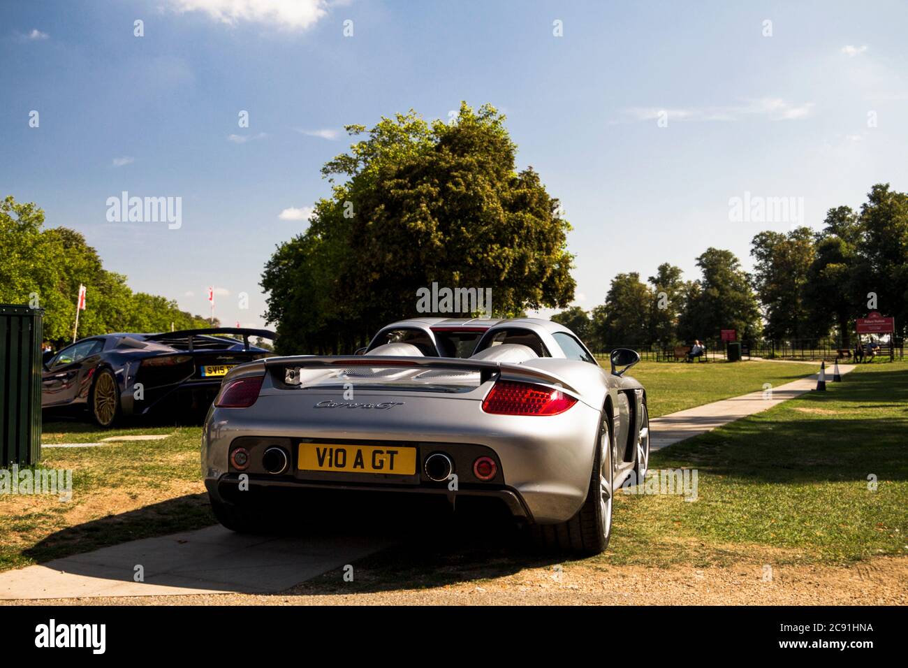 Silver Porsche Carrera GT modern supercar arriving to an annual automotive event held in Oxfordshire. Stock Photo