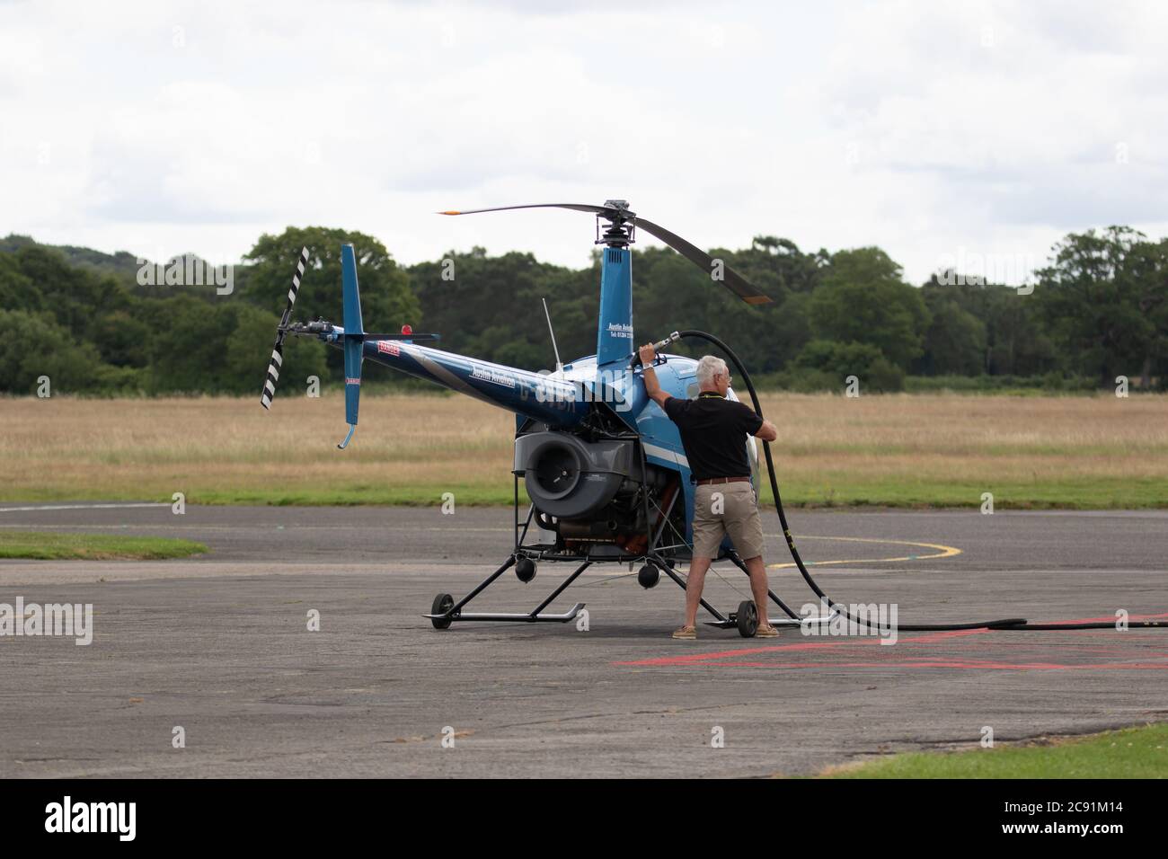 Small helicopter being refuelled. Wolverhampton Halfpenny Green Airfield. Staffordshire. UK Stock Photo