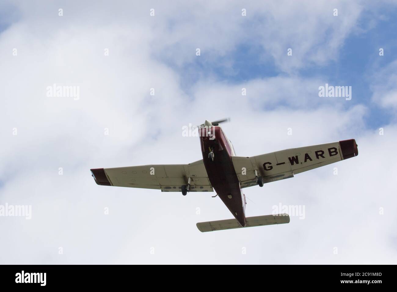 Light aircraft in flight just after takeoff., Wolverhampton Halfpenny Green Airport. Staffordshire, UK Stock Photo