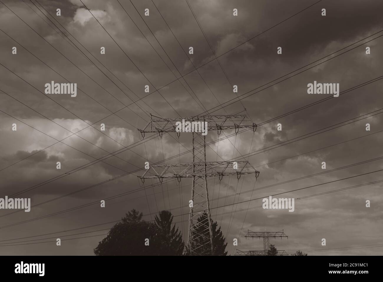Power line masts and cloudy sky Stock Photo - Alamy