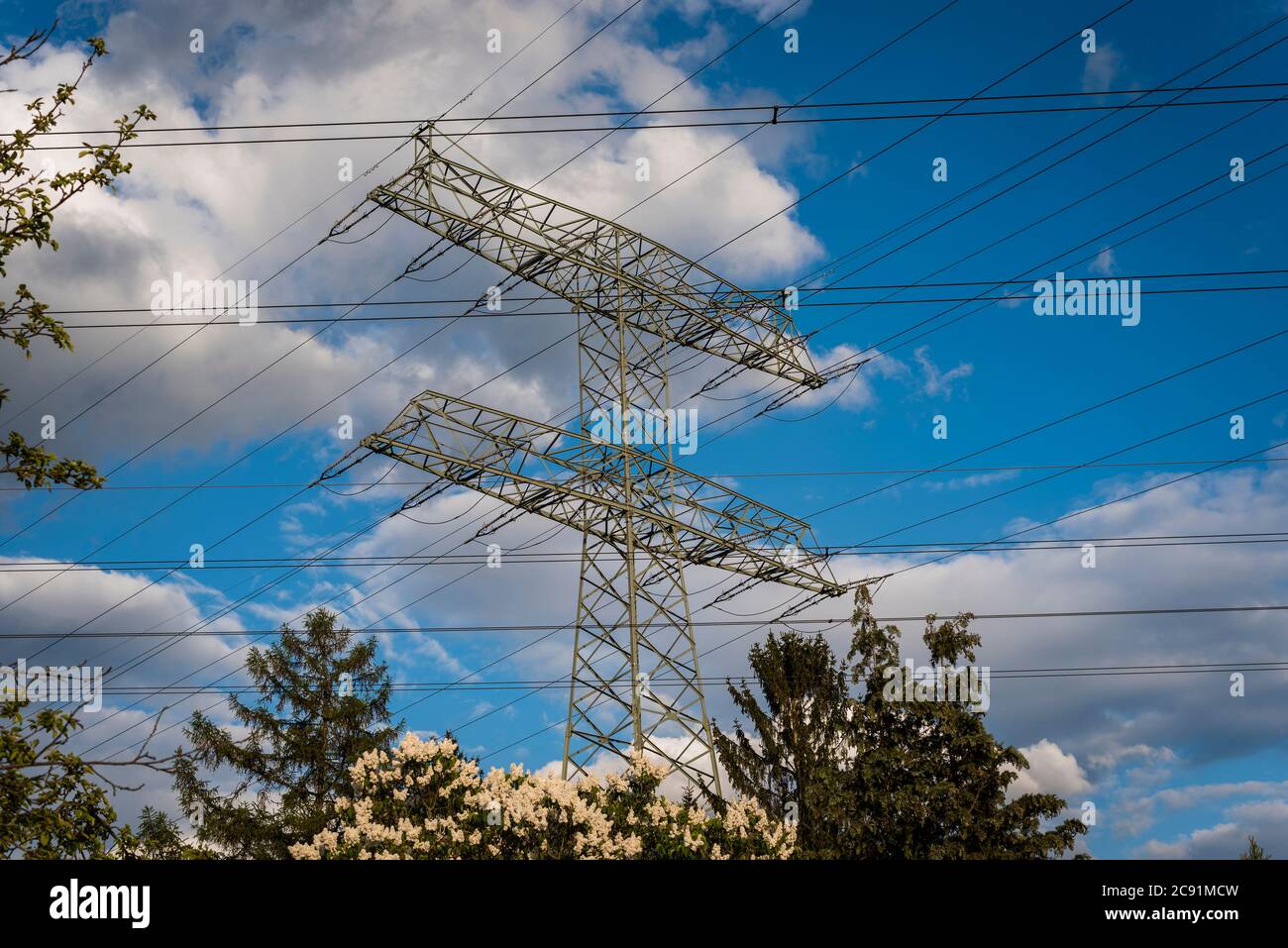 Power line masts and cloudy sky Stock Photo - Alamy