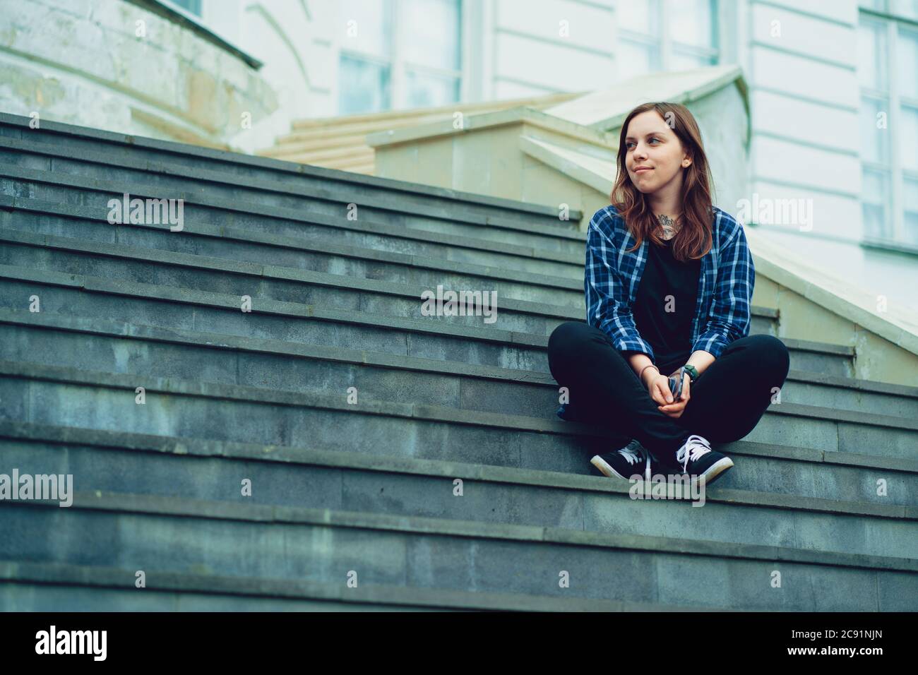 Young pretty woman poses on stairs of manor. Adult smiley female sitting on  steps of Palace Stock Photo - Alamy