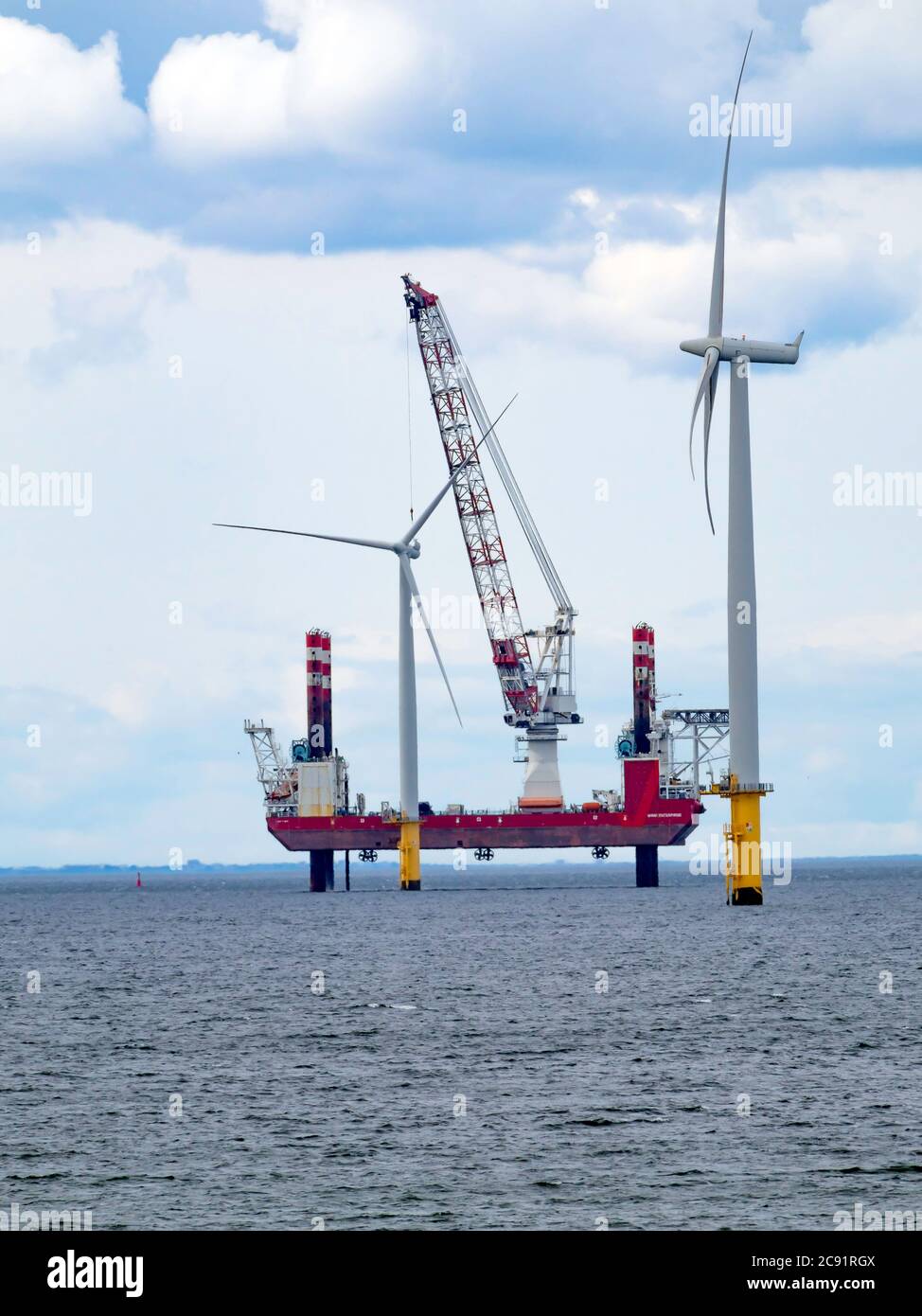 Jack Up heavy lift vessel Wind Enterprise in position with the crane ready to carry out maintenance at Redcar Wind Farm July 2020 Stock Photo