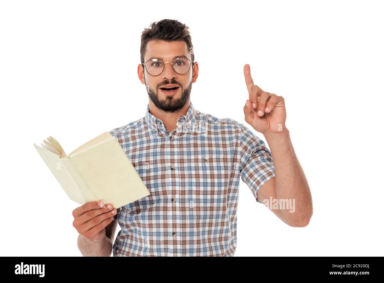 Excited nerd having idea while holding open book isolated on white Stock Photo