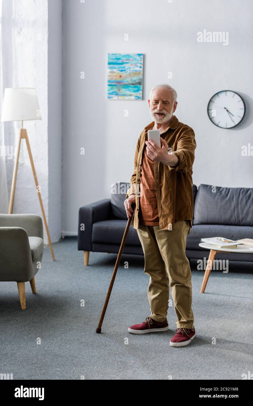 Senior man with walking stick hi-res stock photography and images - Alamy