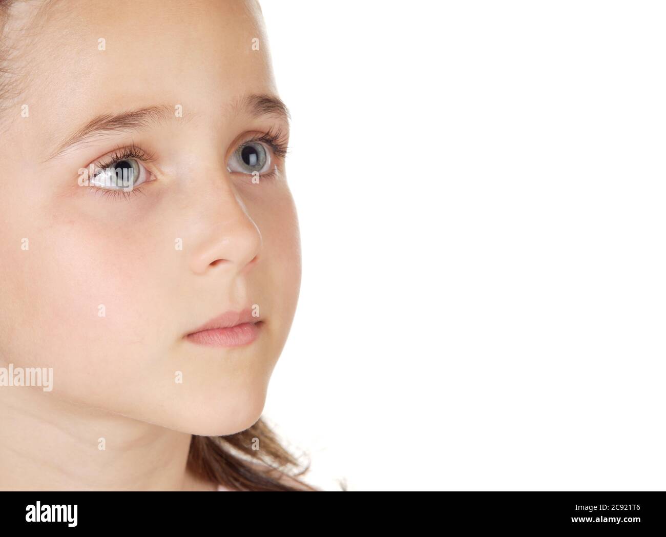 Beautiful little girl with blue eyes looking up isolated on a white