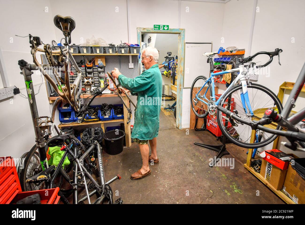 Paul Bradley, bike technician at Briscycle, an independent bike repair service, sales and bicycle recycling centre, repairs a customer's bike at the Brislington workshop in Bristol, as the shop is participating in the Government's delayed bike repair scheme, which has been launched, offering £50 vouchers towards the cost of fixing a bike. The Fix Your Bike initiative forms part of Prime Minister Boris Johnson's plans for a 'new golden age for cycling' with more bike lanes and safer junctions. Stock Photo