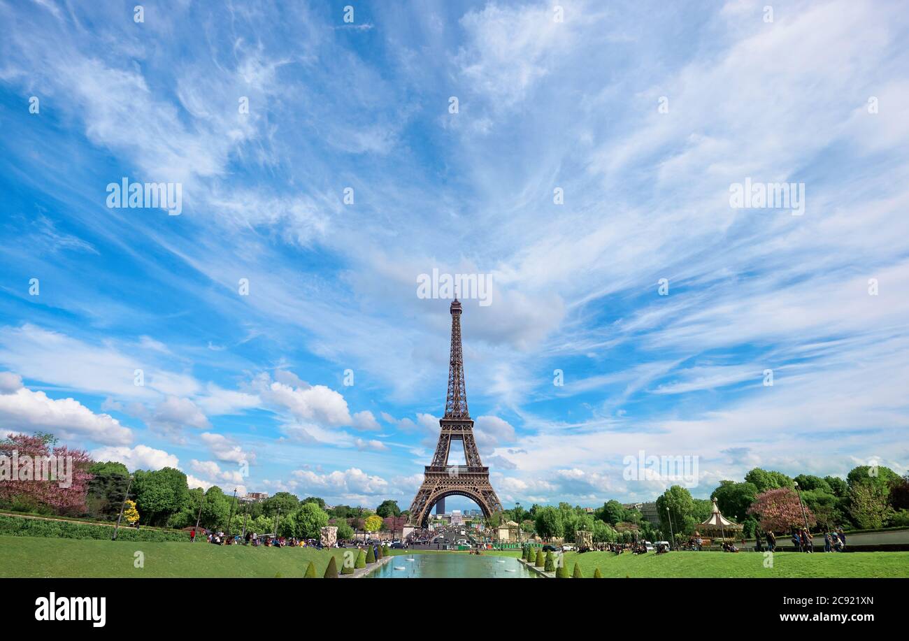 Symmetrical front panoramic view of Eiffel tower on the bright sunny afternoon taken from fountains of Trocadero. Stock Photo