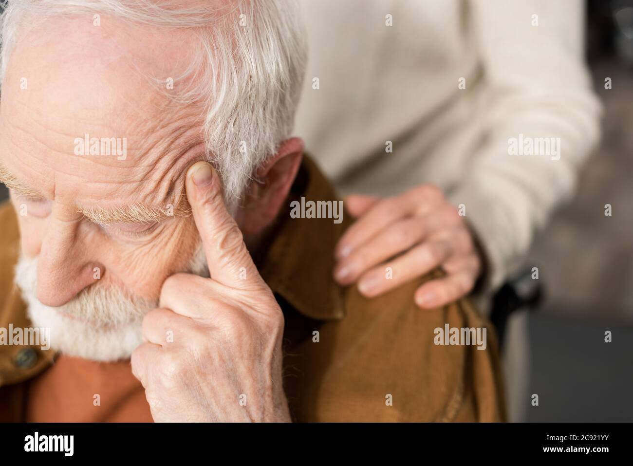 cropped view of woman touching shoulder of husband, sick on dementia