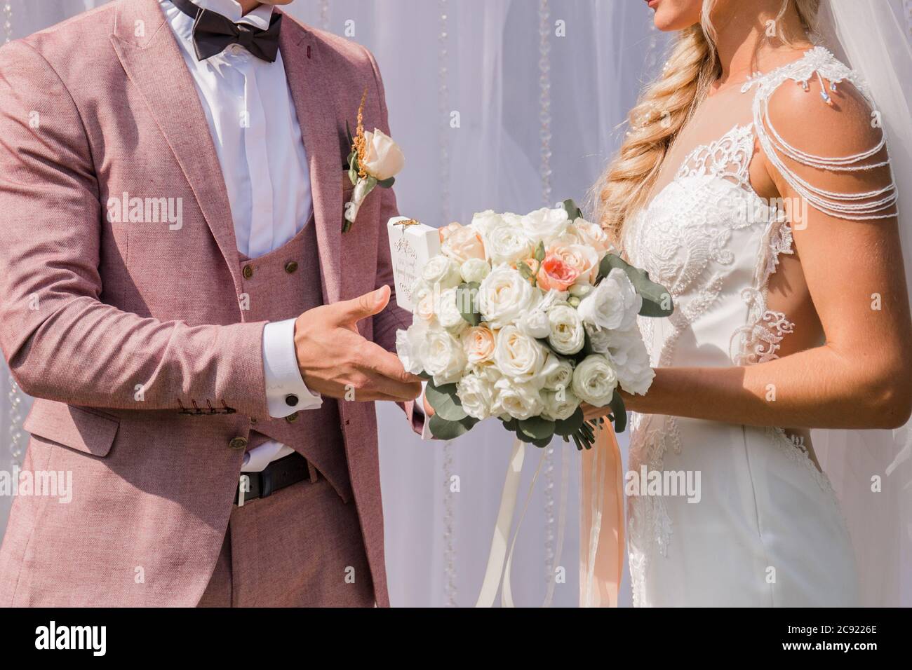 a groom with bride near the wedding arch Stock Photo - Alamy