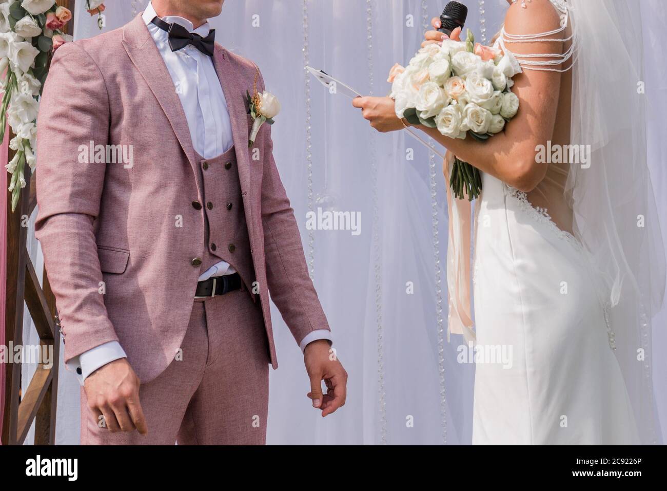 a groom with bride near the wedding arch Stock Photo - Alamy