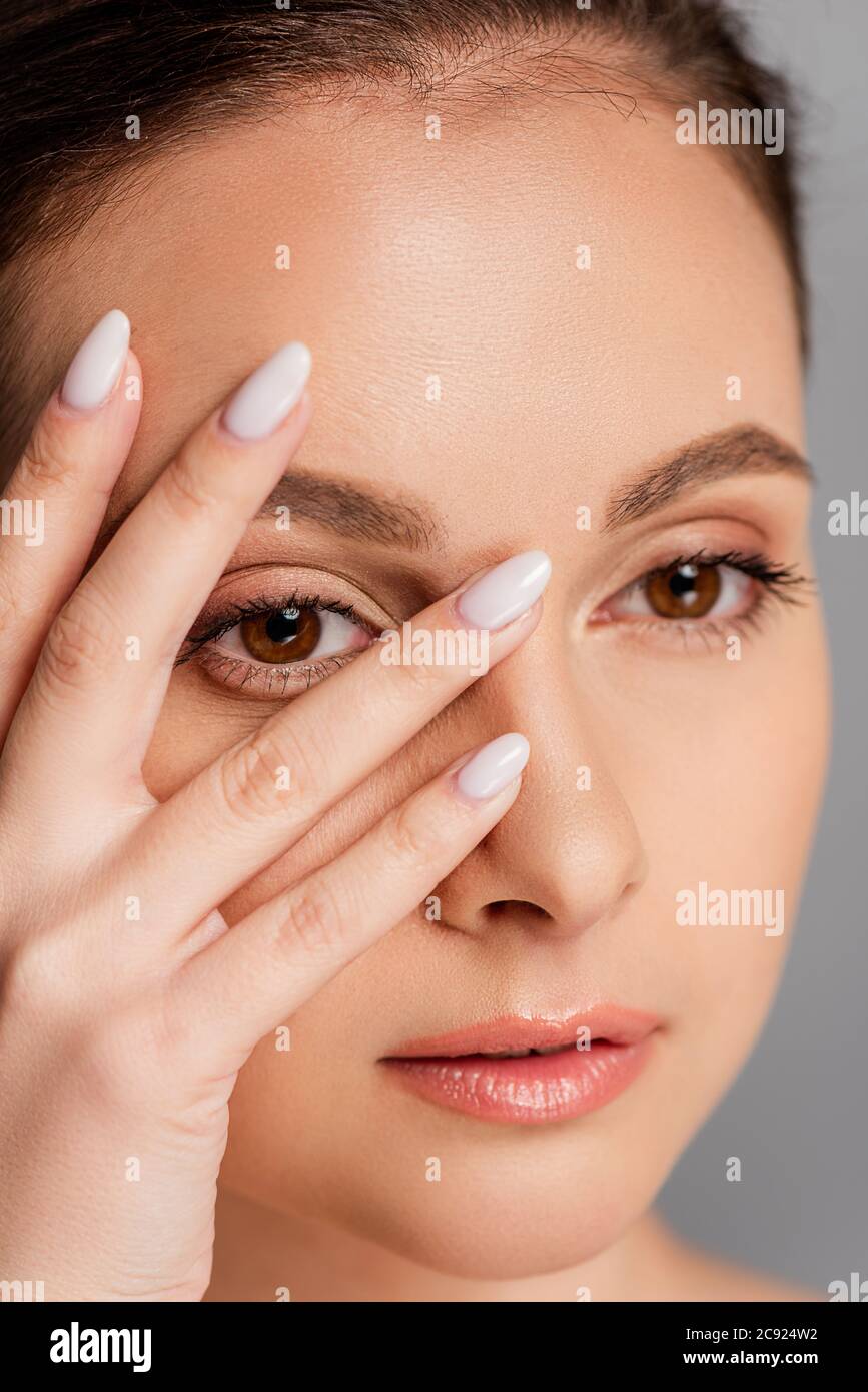 portrait of beautiful woman with perfect skin touching face isolated on ...