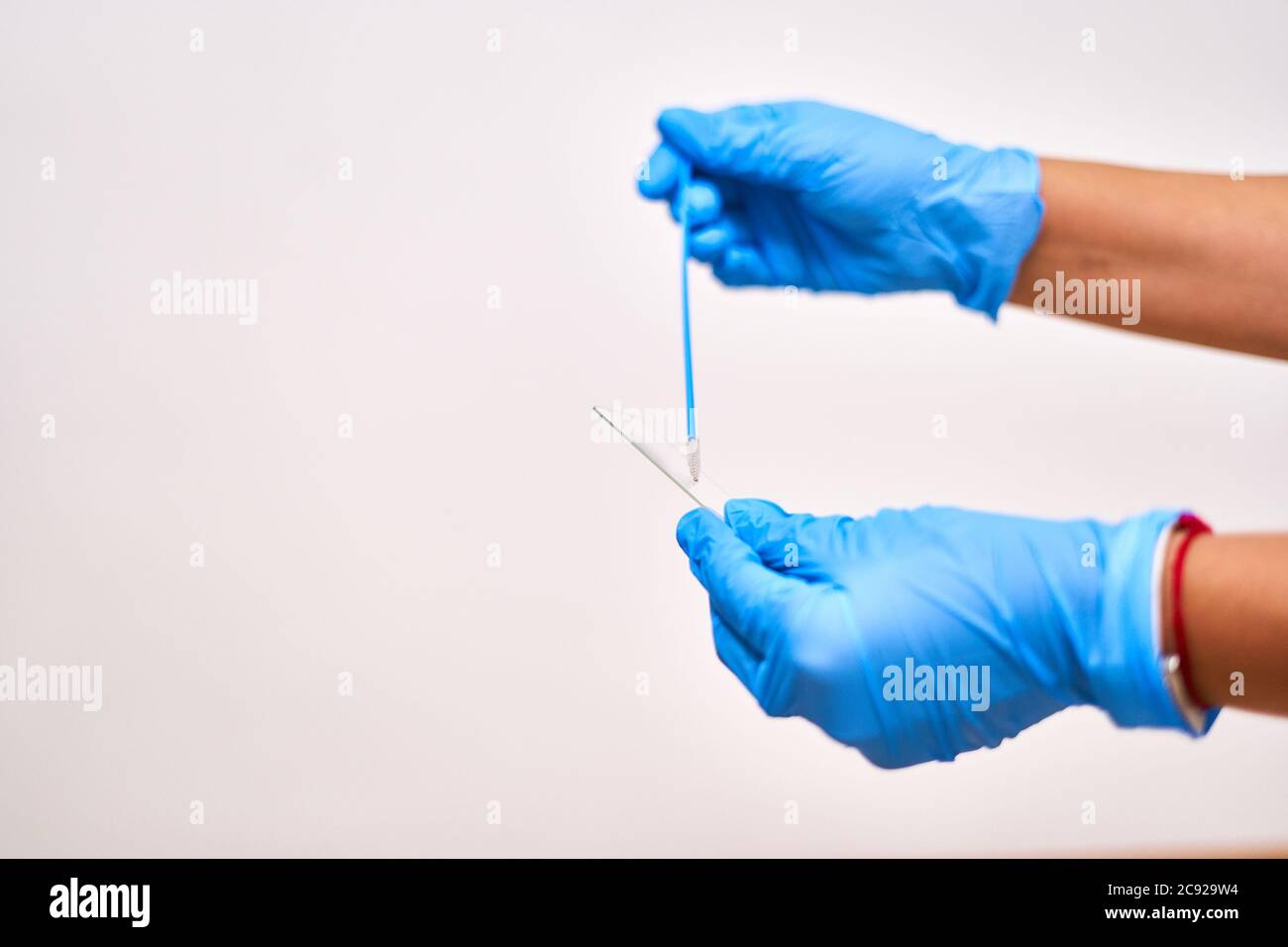 Doctor's hands in blue gloves collecting tests for testing. High ...