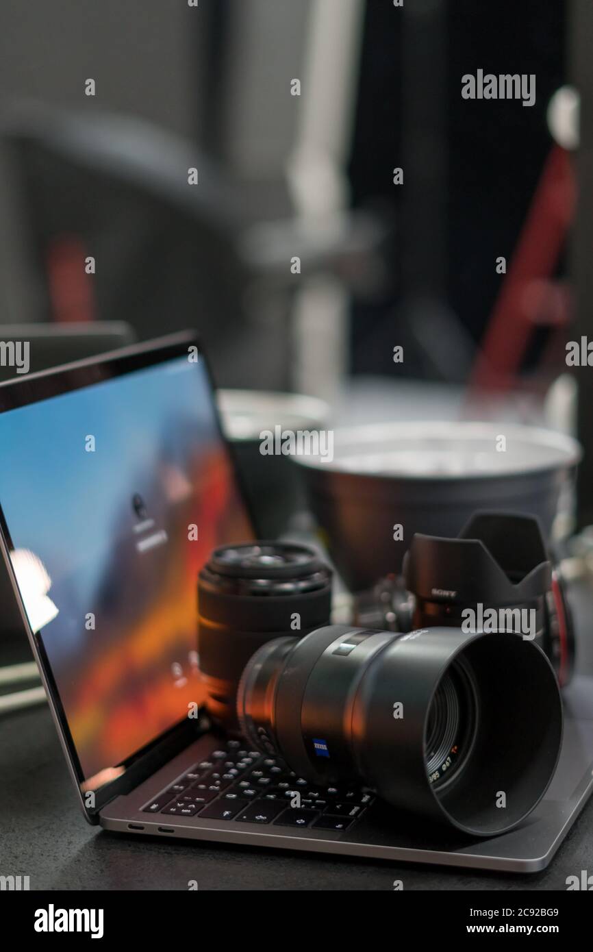 Digital camera, lens and laptop. concept of photographer work station