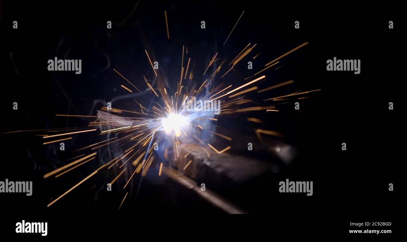 welder working with electrode at semi-automatic arc welding in manufacture production plant Stock Photo
