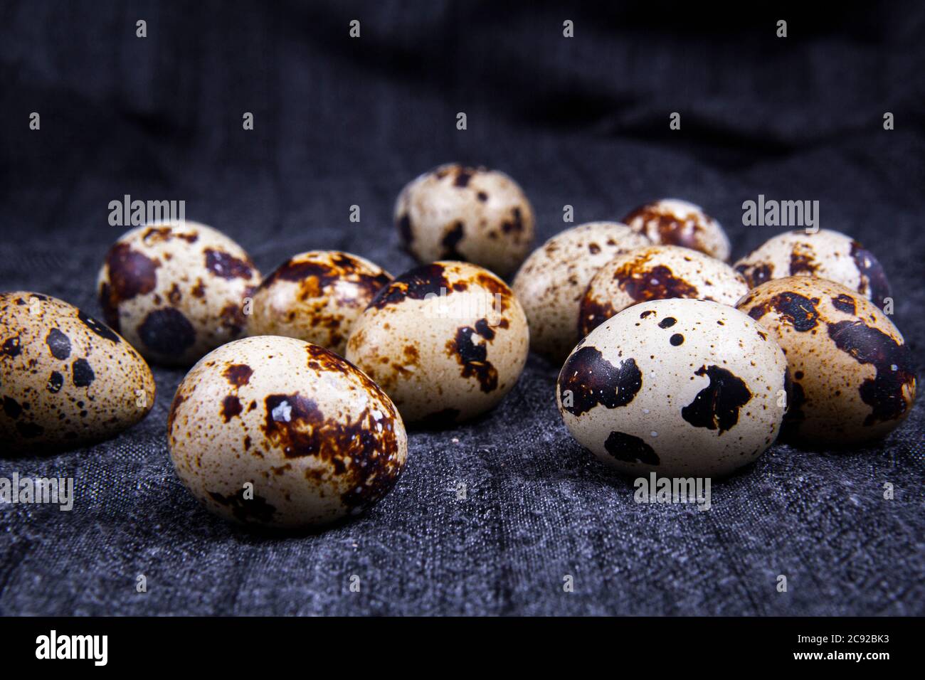 Healthy quail eggs are regularly or irregularly placed inside or outside the container. Stock Photo