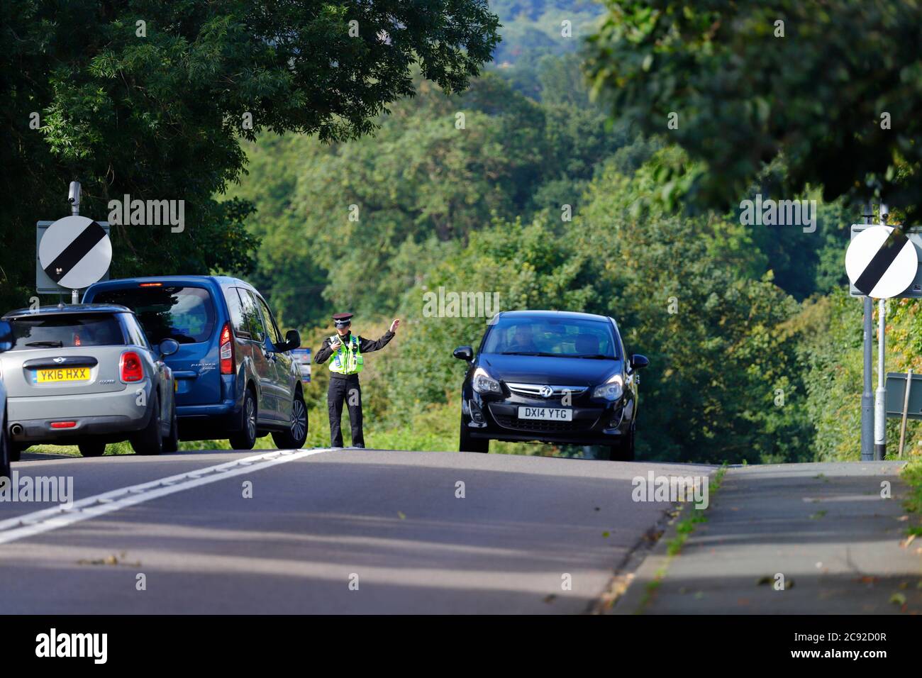 A police officer diverts traffic away from the scene of an accident on Wakefield Road in Swillington. Stock Photo