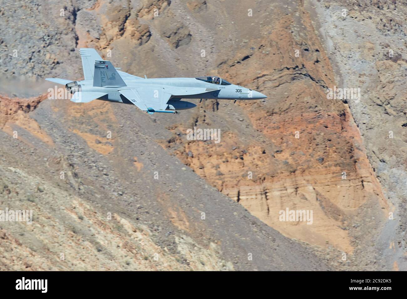 US Navy F/A-18E Super Hornet Flying At Low Level and High Speed Through Rainbow Canyon, California, USA. Stock Photo