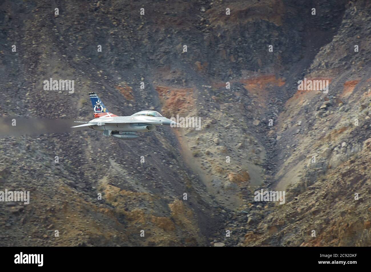 Royal Danish Air Force F-16 Flying At Low Level And High Speed Though Rainbow Canyon, California, USA. Stock Photo