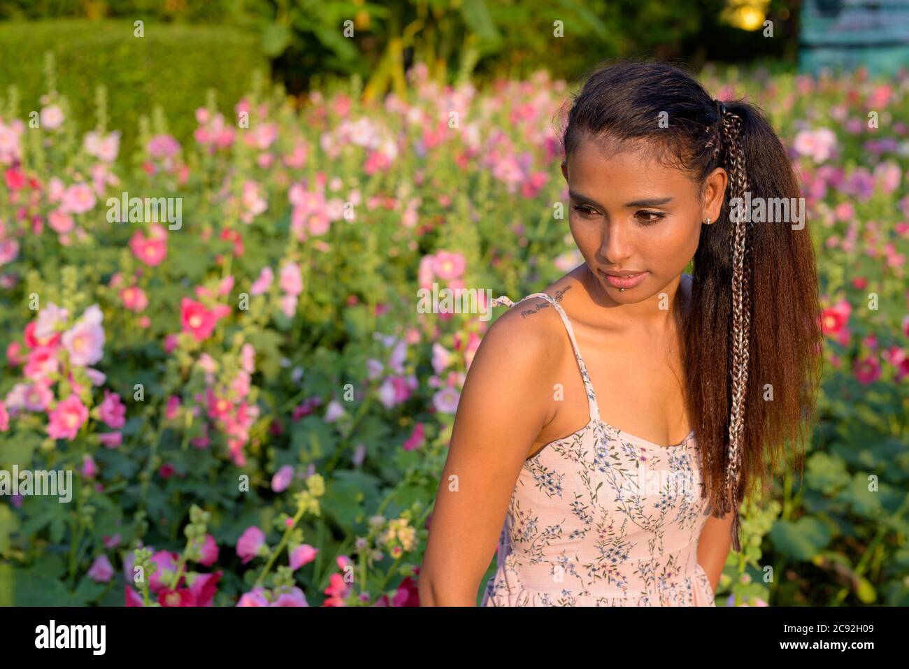 Young beautiful Asian woman relaxing at the park Stock Photo