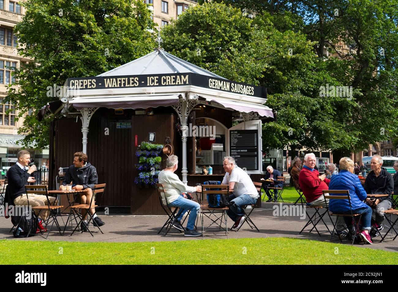 Edinburgh, Scotland, UK. 28 July, 2020. Business and tourism slowly returning to the shops and streets of Edinburgh city centre. The public returning to enjoy cafe inside East Princes Street Gardens which have recently reopened after landscaping and drainage improvement works. Iain Masterton/Alamy Live News Stock Photo